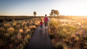 Parent and preschooler walking on a path outside following the best at home preschool curriculum activity.