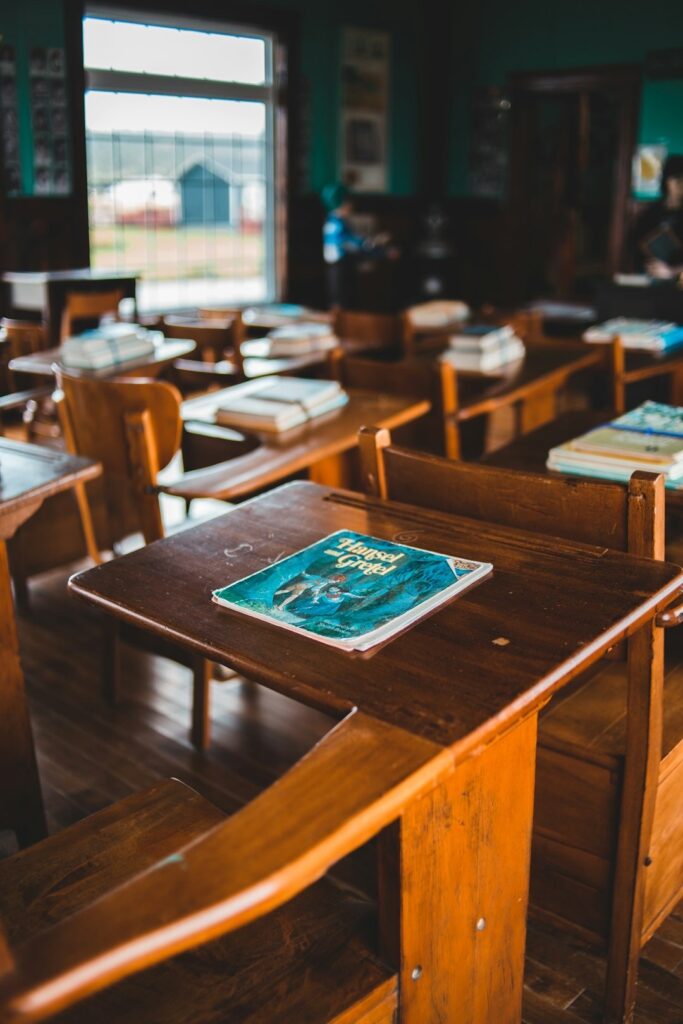 historic classroom with wooden desks and vintage books for young children
