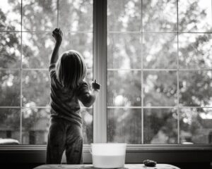 Chores for children being done by a preschooler washing windows.